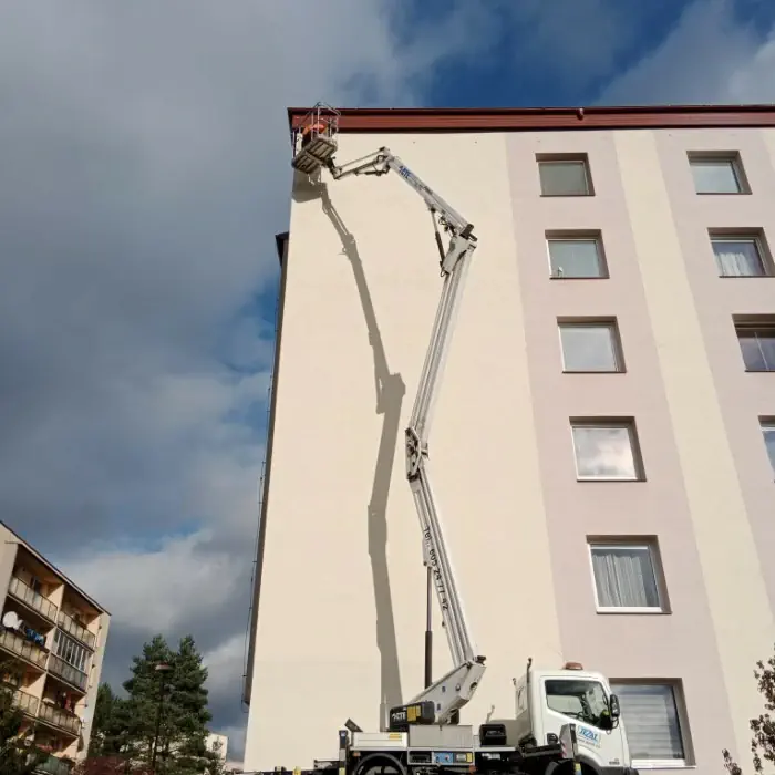 Vysokozdvižná plošina na stavbě používána k natírání fasády